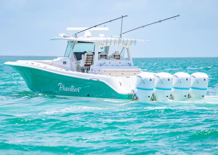  Yacht Photos Pics HCB 53 Sueños 2021 boat with multiple engines cruising on turquoise ocean waters.