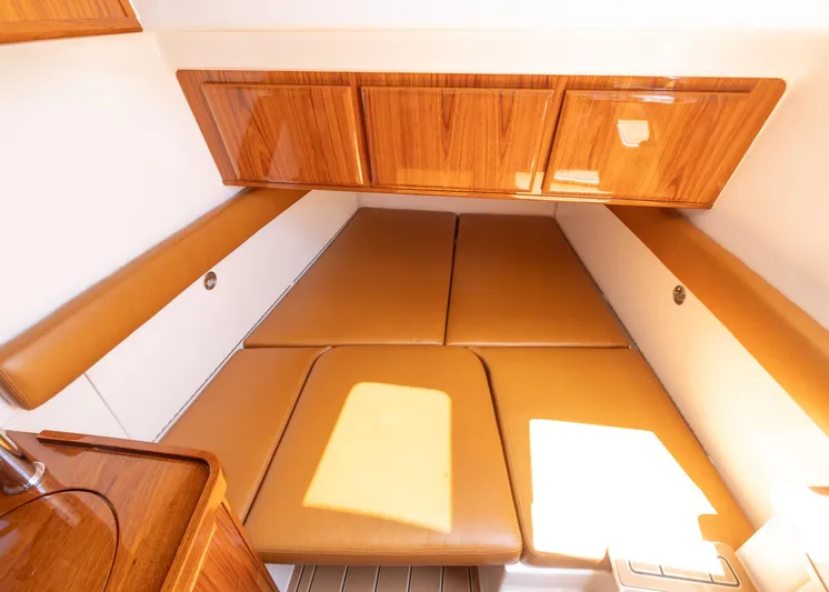  Yacht Photos Pics Interior cabin of 2021 HCB 53 Sueños with wooden cabinets and tan cushions.