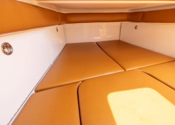  Yacht Photos Pics 2021 HCB 53 Sueños interior cabin with tan cushions and white walls.