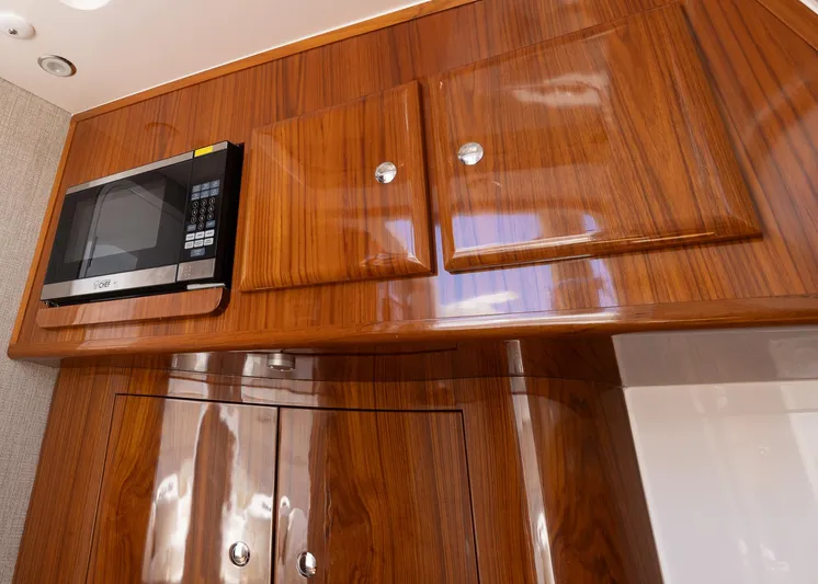  Yacht Photos Pics Luxurious wooden cabinetry with a built-in microwave in the 2021 HCB 53 Sueños yacht.