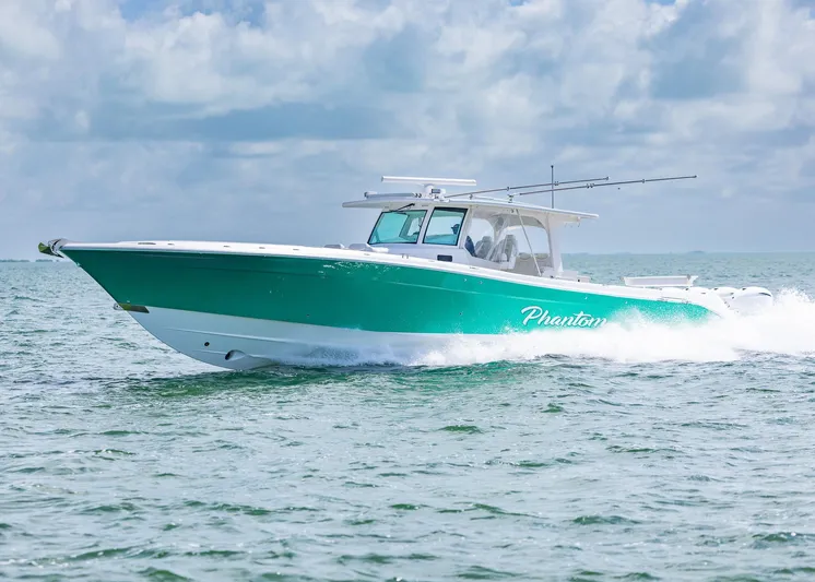  Yacht Photos Pics 2021 HCB 53 Sueños boat cruising on open water under a cloudy sky.