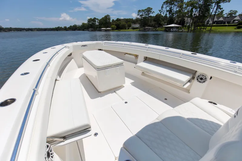  Yacht Photos Pics 2020 Invincible 39 Open Fisherman boat interior with seating and storage, on a calm lake.