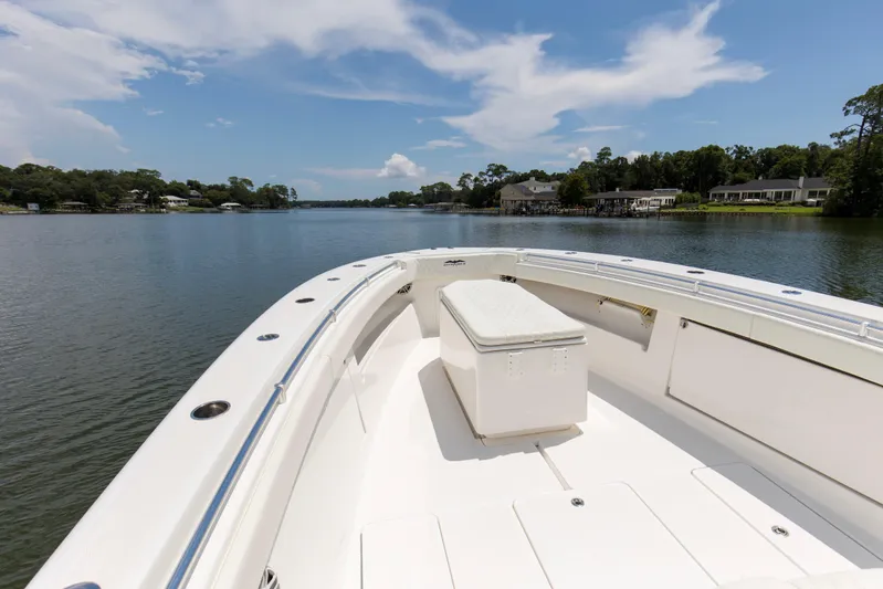  Yacht Photos Pics 2020 Invincible 39 Open Fisherman boat on a serene lake with clear skies.