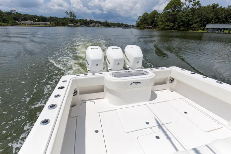  Yacht Photos Pics 2020 Invincible 39 Open Fisherman boat cruising on a scenic lake with triple engines.