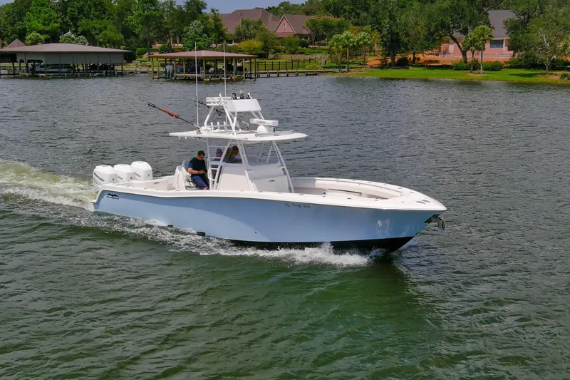  Yacht Photos Pics 2020 Invincible 39 Open Fisherman boat cruising on a scenic lake.