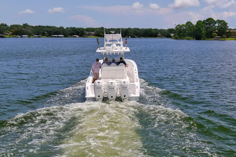  Yacht Photos Pics 2020 Invincible 39 Open Fisherman boat cruising on a scenic lake.