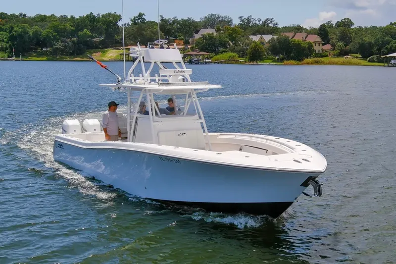  Yacht Photos Pics 2020 Invincible 39 Open Fisherman boat cruising on a scenic lake.