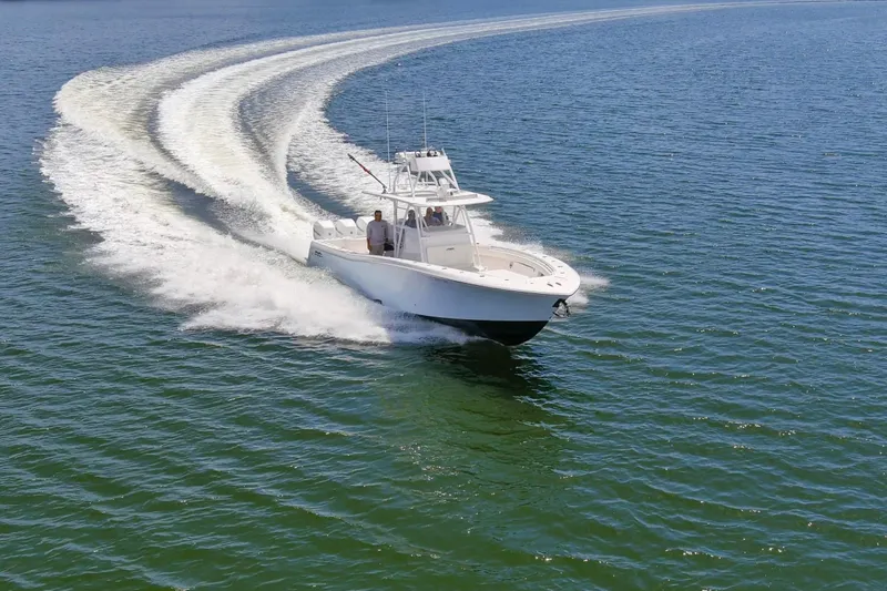  Yacht Photos Pics 2020 Invincible 39 Open Fisherman speeding on open water, creating a dynamic wake.