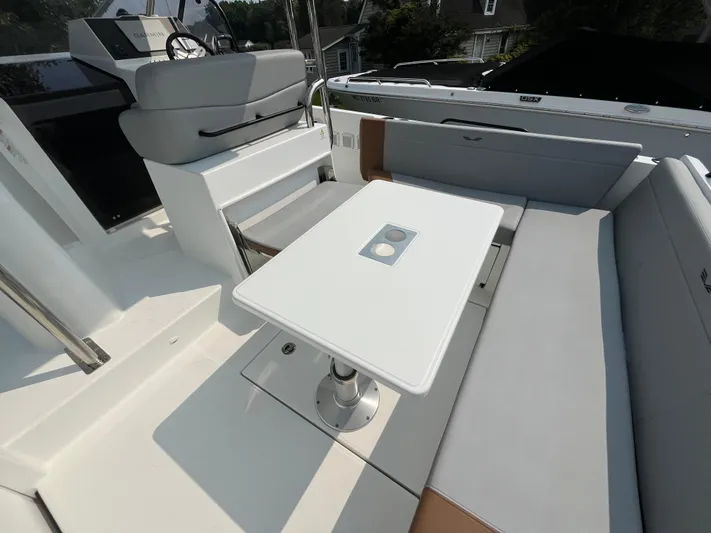  Yacht Photos Pics 2023 Beneteau Flyer 9 SUNdeck interior with seating and table.
