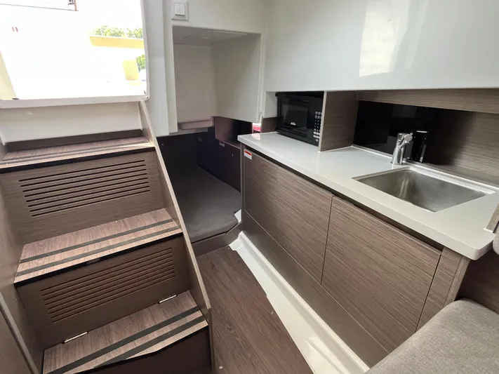 Yacht Photos Pics Interior of 2023 Beneteau Flyer 9 SUNdeck with modern kitchenette and stairs.