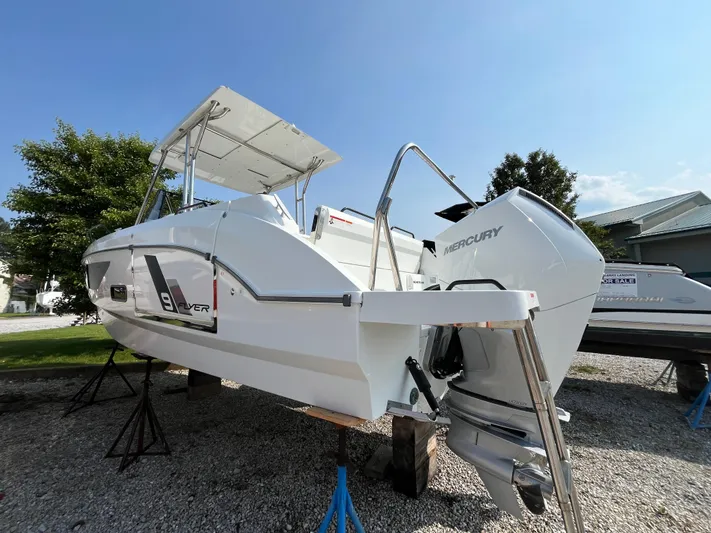  Yacht Photos Pics 2023 Beneteau Flyer 9 SUNdeck boat with Mercury engine, displayed outdoors on stands.