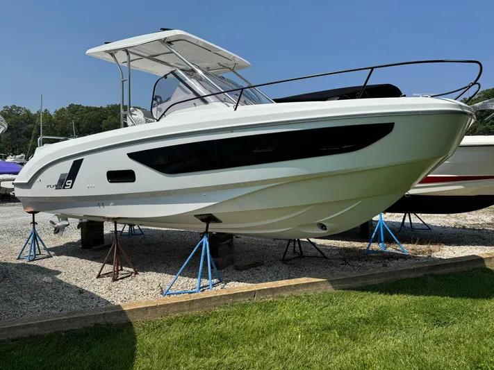  Yacht Photos Pics 2023 Beneteau Flyer 9 SUNdeck boat displayed on stands outdoors.