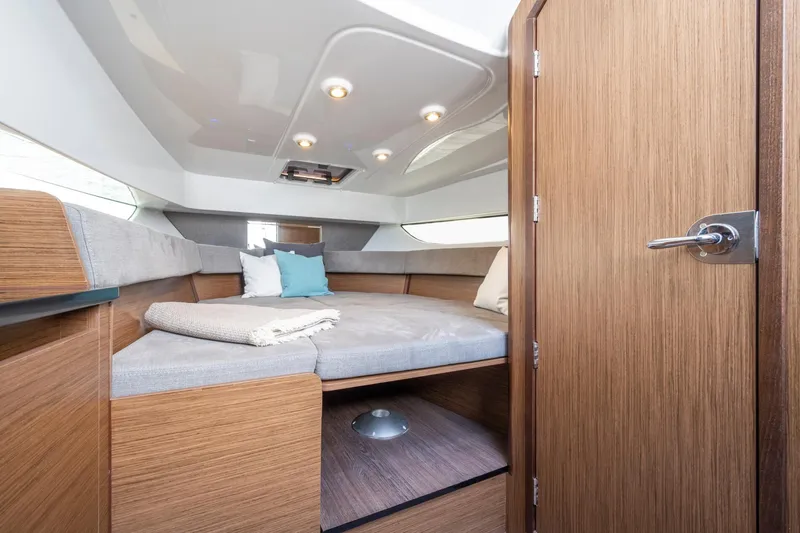  Yacht Photos Pics 2023 Beneteau Flyer 9 SUNdeck cabin interior with cozy bedding and modern design.