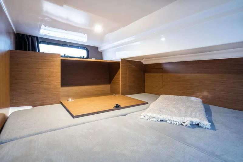  Yacht Photos Pics 2023 Beneteau Flyer 9 SUNdeck cabin interior with wooden finish and cozy bedding.