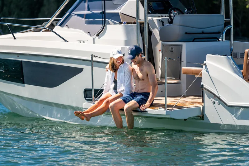 Yacht Photos Pics Couple relaxing on a 2023 Beneteau Flyer 9 SUNdeck, enjoying the water.