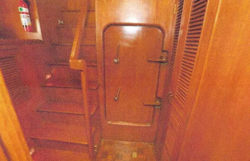 Wendy Lynn Yacht Photos Pics 1984 Ocean Alexander Flying Bridge Motor Yacht interior with wooden stairs and door.