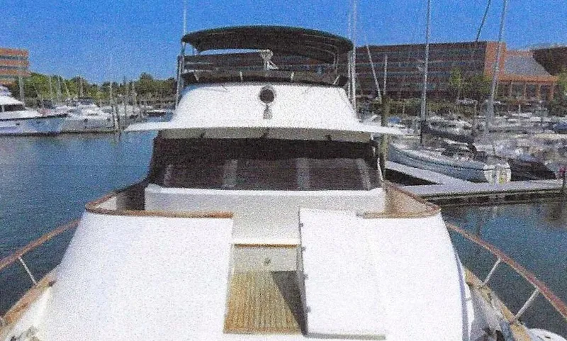 Wendy Lynn Yacht Photos Pics 1984 Ocean Alexander Flying Bridge Motor Yacht docked in marina, sunny day, clear blue sky.