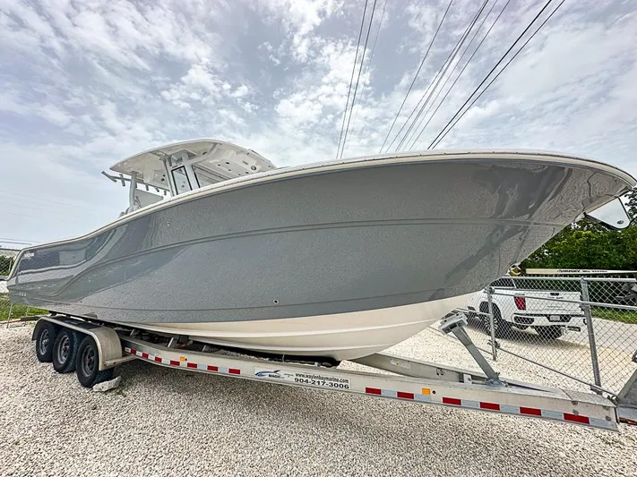  Yacht Photos Pics 2024 Sea Fox 328 Commander boat on trailer, side view, cloudy sky background.