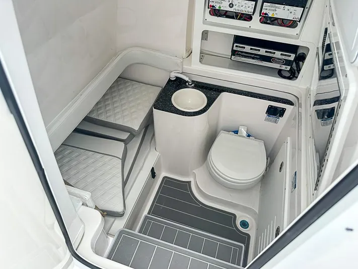 Yacht Photos Pics 2024 Sea Fox 328 Commander interior with toilet, sink, and cushioned seating.