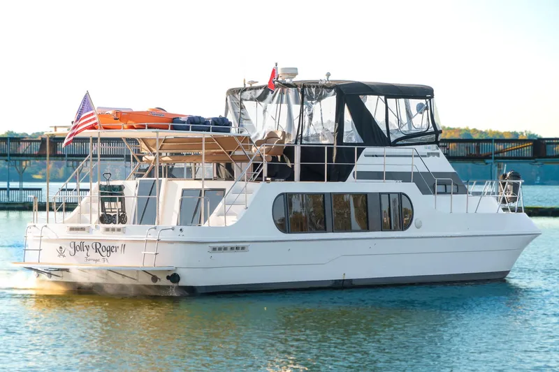 Jolly Roger II Yacht Photos Pics 1997 Harbor Master Stolkraft yacht on water, featuring "Jolly Roger II" name and American flag.