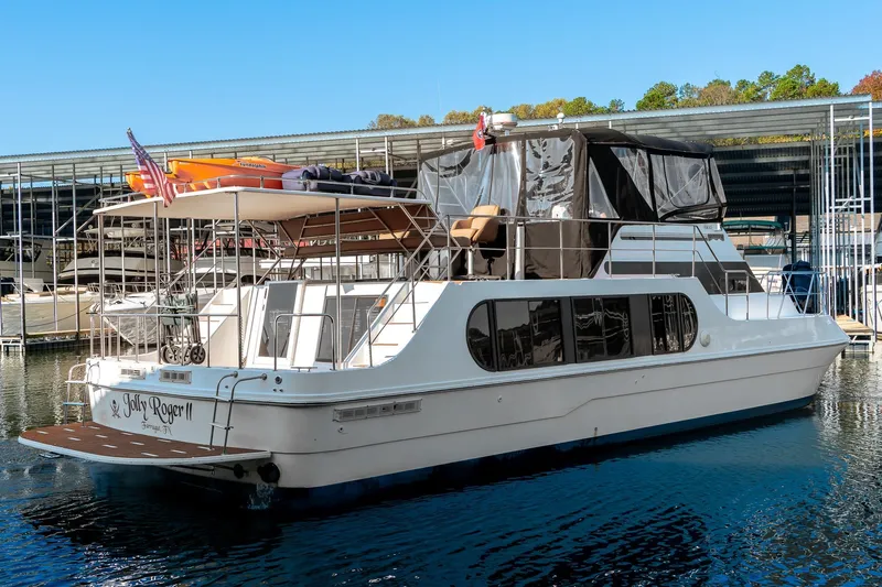 Jolly Roger II Yacht Photos Pics 1997 Harbor Master Stolkraft yacht docked, featuring upper deck and American flag.
