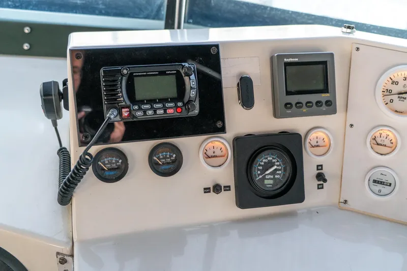 Jolly Roger II Yacht Photos Pics Control panel of a 1997 Harbor Master Stolkraft boat with gauges and radio equipment.
