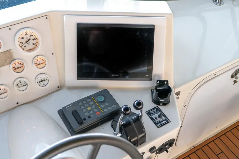 Jolly Roger II Yacht Photos Pics 1997 Harbor Master Stolkraft boat dashboard with gauges, controls, and Garmin display.