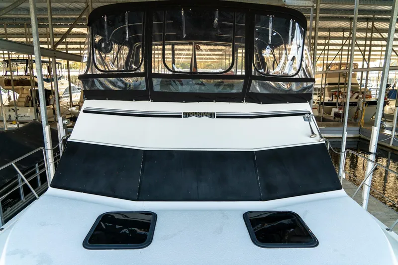 Jolly Roger II Yacht Photos Pics 1997 Harbor Master Stolkraft boat docked in a marina, featuring a covered upper deck.