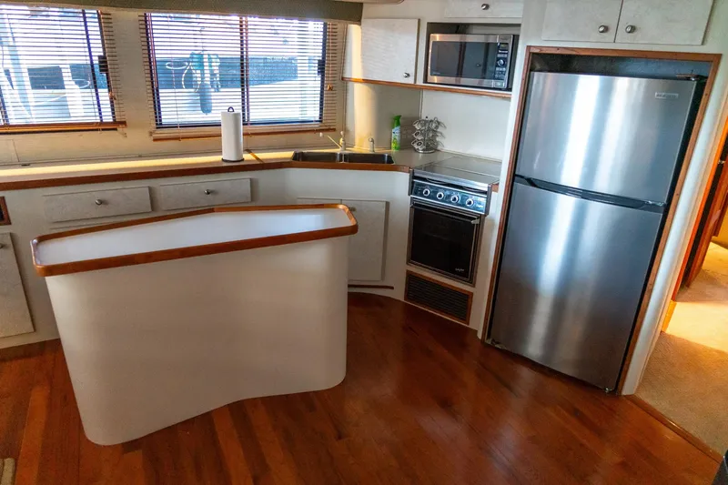 Jolly Roger II Yacht Photos Pics 1997 Harbor Master Stolkraft kitchen with modern appliances and wooden flooring.