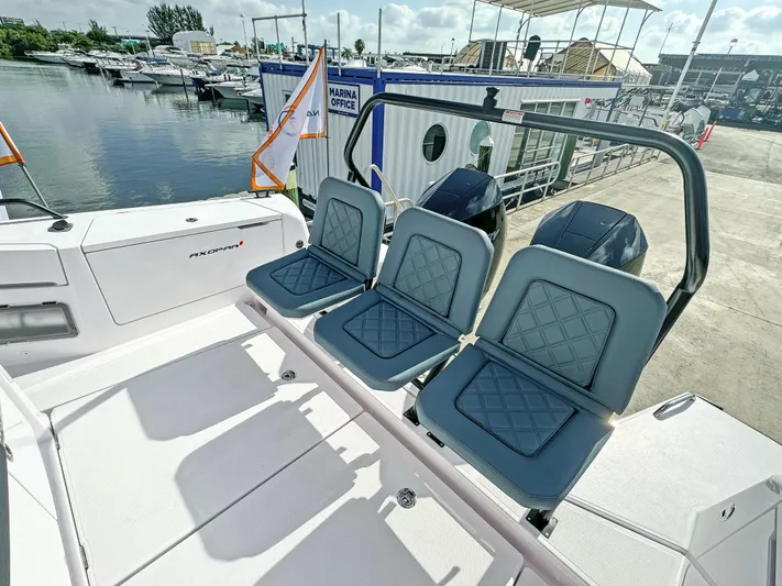  Yacht Photos Pics 2024 Axopar 37 Sun Top boat with stylish seating at a marina.