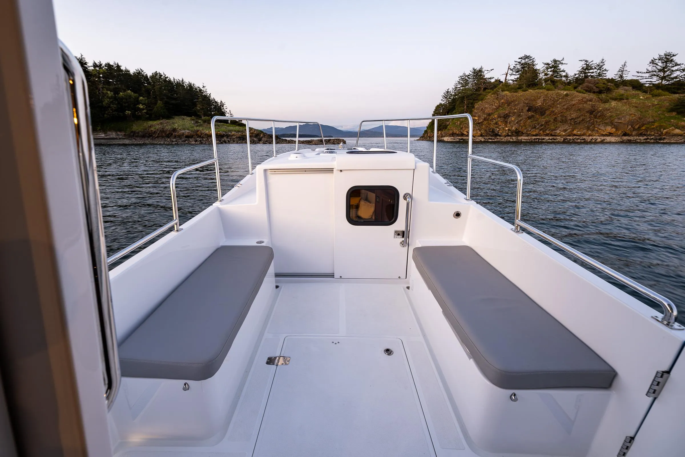 2025 SeaPiper 37 boat deck with seating, surrounded by calm waters and scenic islands.