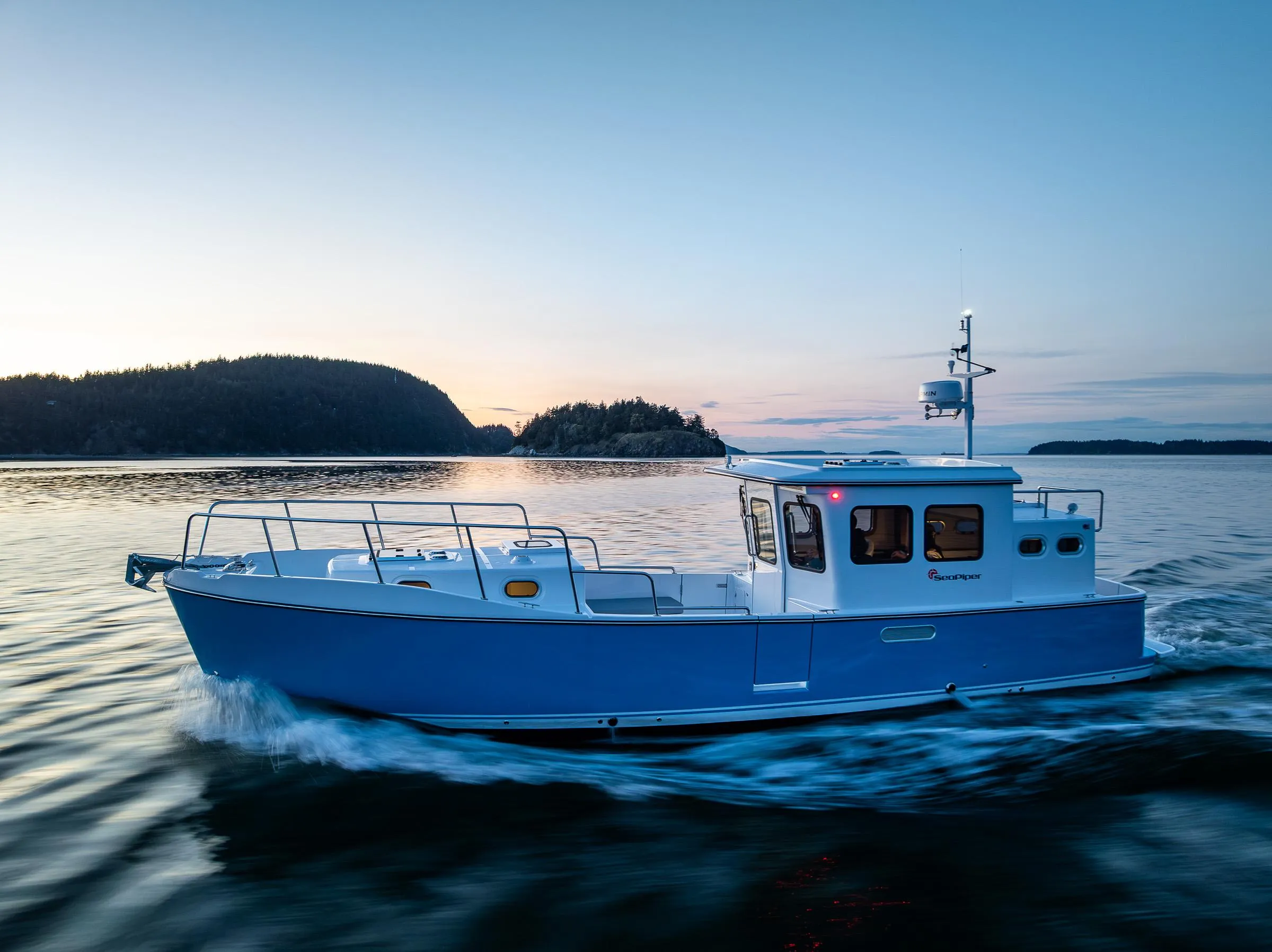 2025 SeaPiper 37 cruising at sunset on calm waters.