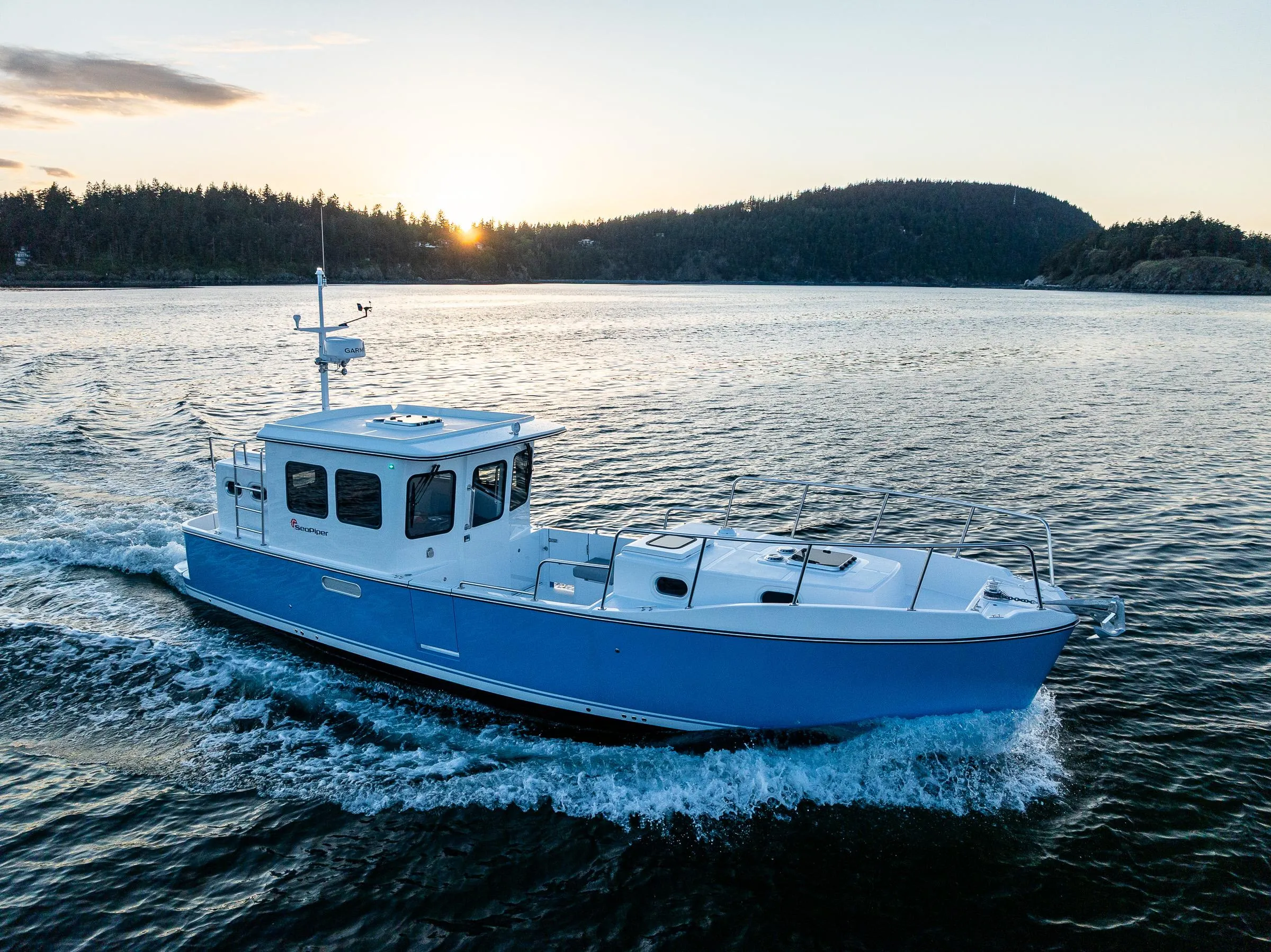 2025 SeaPiper 37 cruising on a serene lake at sunset.