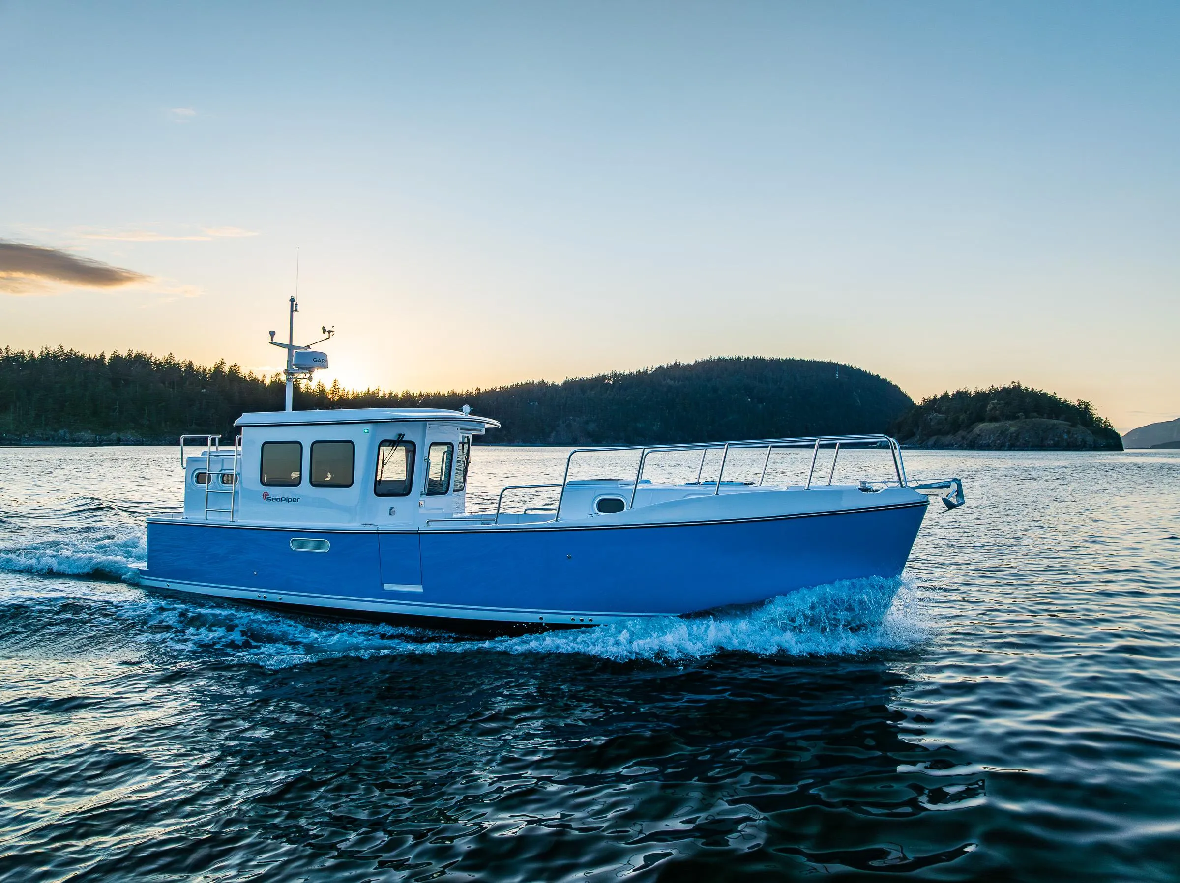 2025 SeaPiper 37 cruising on serene waters at sunset.