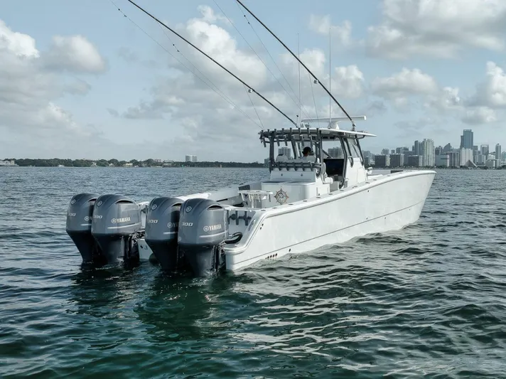 Due East Yacht Photos Pics 2017 Freeman 42LR boat with four Yamaha engines on open water, city skyline in background.