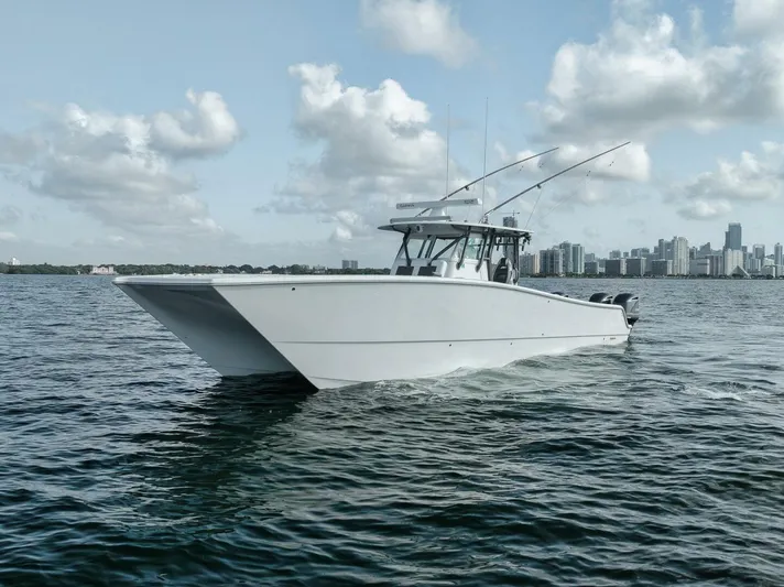 Due East Yacht Photos Pics Freeman 42LR 2017 boat cruising on water with city skyline in background.