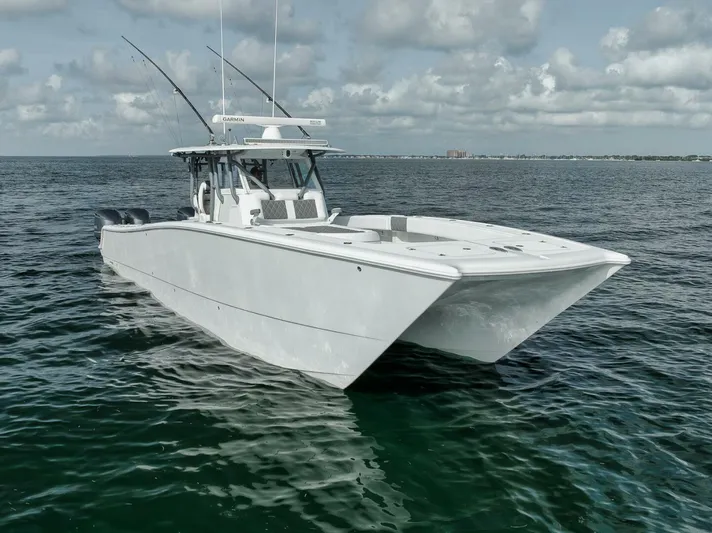 Due East Yacht Photos Pics 2017 Freeman 42LR boat on calm ocean waters under cloudy sky.