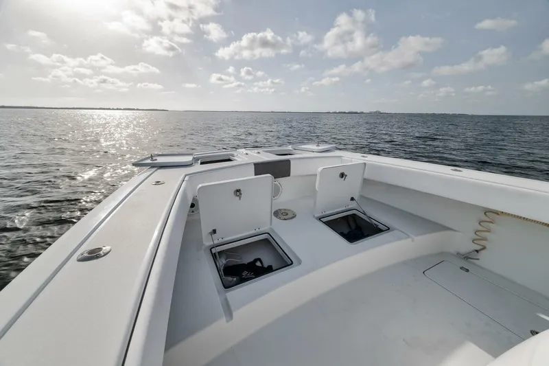 Due East Yacht Photos Pics Bow view of 2017 Freeman 42LR boat on open water under a cloudy sky.