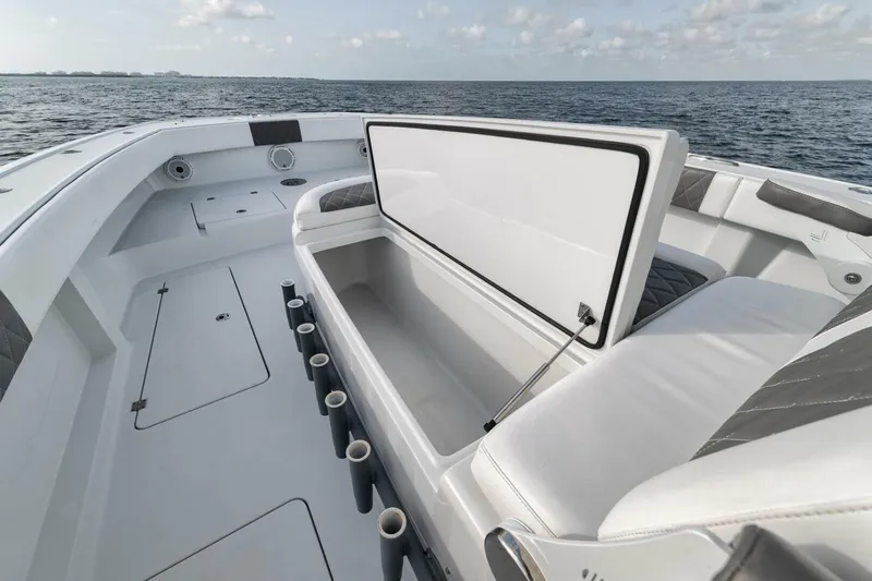 Due East Yacht Photos Pics Open storage compartment on a 2017 Freeman 42LR boat, with ocean backdrop.