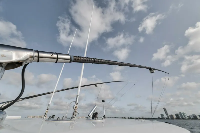 Due East Yacht Photos Pics Fishing rods on a 2017 Freeman 42LR boat under a cloudy sky.