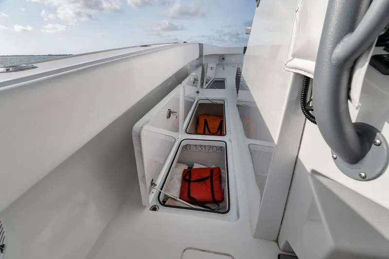 Due East Yacht Photos Pics Freeman 42LR 2017 boat interior with open storage compartments and life jackets.