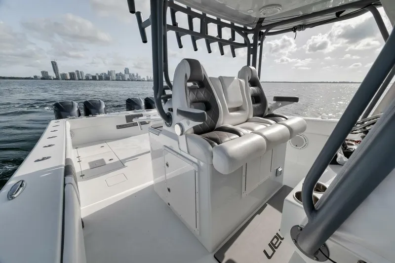 Due East Yacht Photos Pics 2017 Freeman 42LR boat interior with dual seats, ocean view, and city skyline in background.
