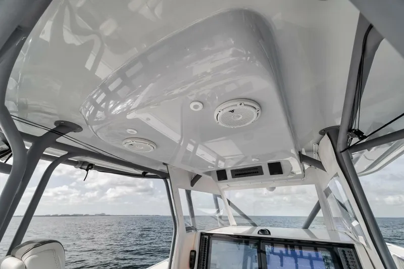 Due East Yacht Photos Pics Interior view of a 2017 Freeman 42LR boat, showcasing the helm and overhead design.