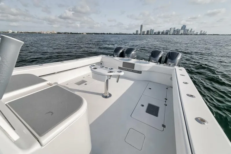 Due East Yacht Photos Pics 2017 Freeman 42LR boat with city skyline in background, featuring spacious deck and multiple engines.
