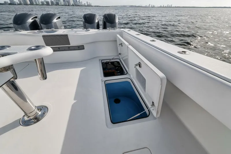 Due East Yacht Photos Pics Freeman 42LR 2017 boat deck with open storage compartments, ocean view in background.