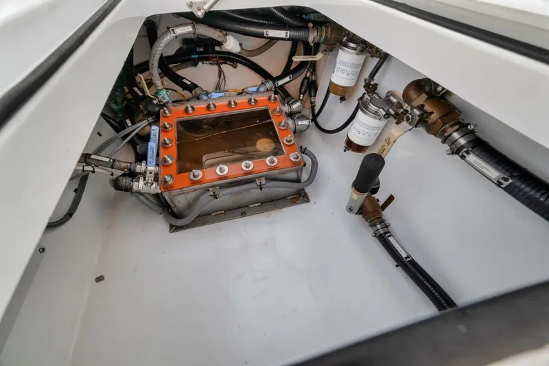 Due East Yacht Photos Pics Engine compartment of a 2017 Freeman 42LR boat, showcasing mechanical components and piping.