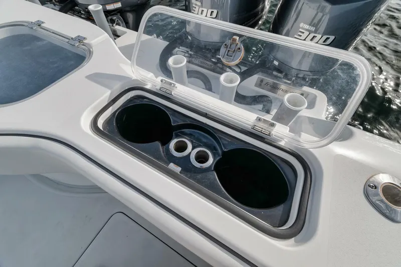 Due East Yacht Photos Pics Open storage compartment on 2017 Freeman 42LR boat with cup holders and Yamaha engines.