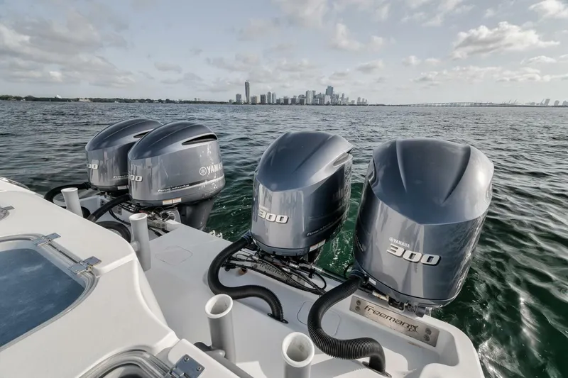 Due East Yacht Photos Pics Four Yamaha outboard motors on a 2017 Freeman 42LR boat with city skyline in background.