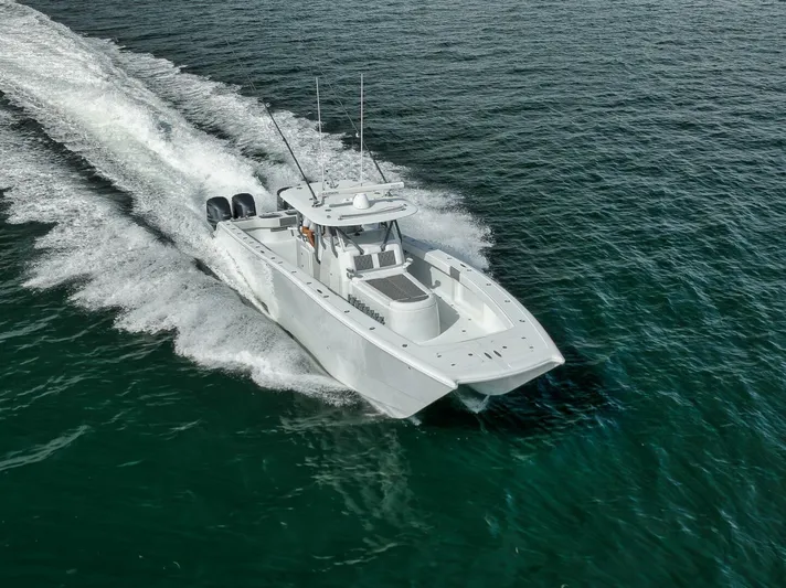 Due East Yacht Photos Pics 2017 Freeman 42LR boat cruising on open water, creating a wake.