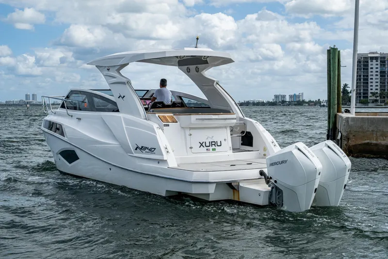 Xuru Yacht Photos Pics 2023 NX 340 boat with dual Mercury engines on a sunny day.